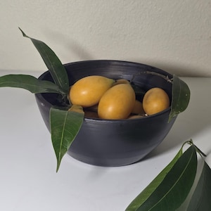 May include: A rustic wooden sign with the text "Welcome to our home" in white lettering. The sign features a distressed finish and a simple, inviting design, perfect for a front porch or entryway.