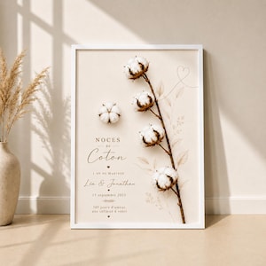 Könnte beinhalten: Ein gerahmter vertikaler Druck auf beigem Hintergrund mit einem braunen Stiel, vier weißen Baumwollblüten und einer einzelnen Baumwollblüte. Der Text lautet: NOCES de Coton, 1 AN DE MARIAGE, Léa & Jonathan, 15 septembre 2025, 365 jours d'amour, une infinité à venir.