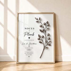 May include: A framed vertical print featuring a metallic silver branch with berries on the right side. The text reads: NOCES de Plomb, 14 ANS DE MARIAGE, Léa & Jonathan, 15 septembre 2010, 5113 jours d'amour, une vie à construire, une vie à bâtir.