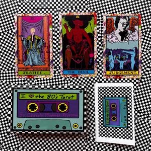 May include: Three tarot cards titled Justice, The Devil, and Judgement displayed above a rectangular box and a small card featuring a purple and teal cassette tape graphic with the text I heart the 80's Tarot by Christy Plummer Reynosa.