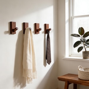 May include: A rustic wooden sign with the text "Welcome to our home" in white lettering. The sign features a distressed finish and a simple, inviting design, perfect for front door decor.