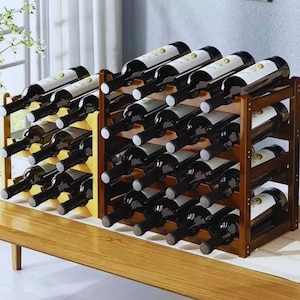 May include: Wooden wine racks filled with wine bottles. The racks are made of dark brown wood and hold multiple bottles at an angle. The bottles are dark with white labels.