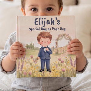 May include: A hardback book titled Elijah's Special Day as Page Boy. The cover features a cartoon illustration of a young boy in a blue suit holding flowers in a field of daisies and lavender, with a wedding arch in the background.