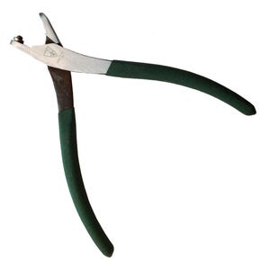 May include: A pair of metal pliers with a silver head and dark green handles. The pliers are open, ready for use, and are set against a white background. The tool appears to be in good condition.