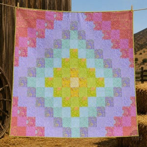 May include: A colorful patchwork quilt with a diamond pattern. The quilt features squares of various colors, including pink, purple, green, and blue, with floral and gingham patterns. The quilt is hanging on a clothesline against a rustic wooden background.