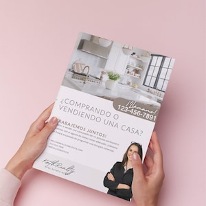 May include: A flyer held by hands, featuring text in Spanish: "¿COMPRANDO O VENDIENDO UNA CASA?" (Buying or Selling a House?). It includes a photo of a kitchen and a woman, with contact information and the words "Kath Realty".