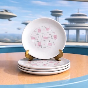 May include: A stack of white ceramic plates with a mid-century modern design. Each plate features a pink and black geometric pattern. The plates are displayed on a gold-colored stand, with a futuristic cityscape in the background.