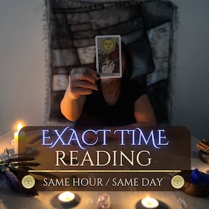 May include: A tarot card titled The Sun featuring a sun illustration, held up in a dimly lit room. Text on the image reads EXACT TIME READING SAME HOUR / SAME DAY. The scene includes lit candles, purple dried flowers, and a dark cloth backdrop.