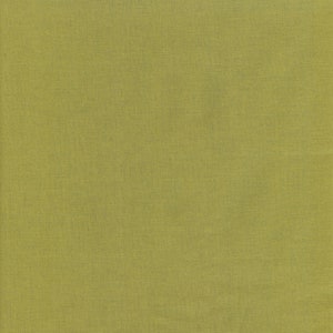 May include: A full-frame shot of a solid, textured fabric in a muted, yellowish-green hue. The fabric's surface has a subtle, woven pattern, creating a slightly rough texture. The color is consistent across the entire frame.