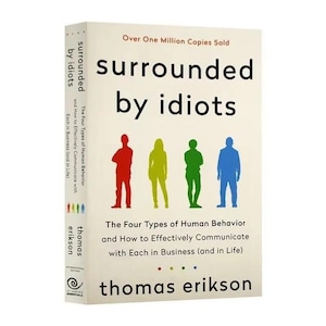 May include: A hardcover book titled "surrounded by idiots" with the author's name, Thomas Erikson, at the bottom. The cover features the title in large black letters, the subtitle, and four colored silhouettes of people.