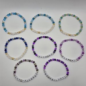 May include: Eight beaded bracelets arranged in a grid. Each bracelet features colorful round beads, metallic spacers, and white letter beads spelling either BLOW ME or THE FAILURES. The bracelets vary in color, including blue, purple, and green tones.