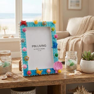 May include: A rectangular light blue photo frame constructed from building blocks, featuring a variety of colorful sea-themed embellishments including crabs, shells, and spheres. The frame displays the text PIN LIVING DIY PHOTO FRAME 4" x 6".