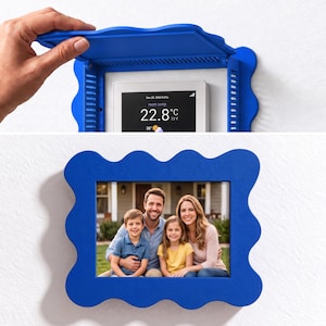 May include: A bright blue, wavy-edged cover for a smart thermostat. The cover features a hinged top that opens to reveal a digital display showing 22.8 degrees Celsius, 73 degrees Fahrenheit, and the date November 29, 2024.