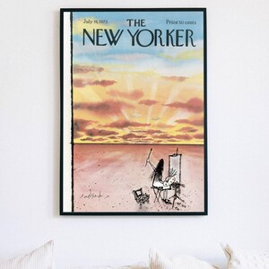 May include: A framed magazine cover titled The New Yorker, dated July 16, 1973, priced at 50 cents. The illustration depicts a person painting at an easel in a vast, pink-toned landscape under a sunset sky with yellow and orange clouds.