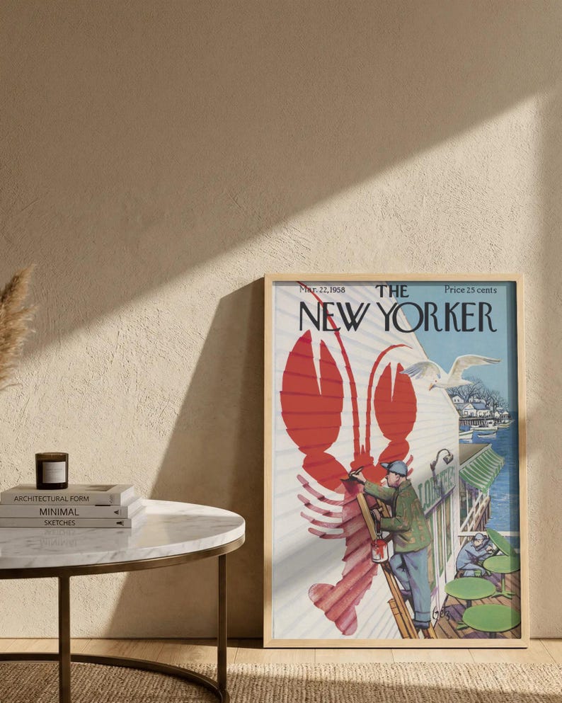 May include: A framed vintage New Yorker magazine cover with a red lobster illustration. The cover art shows a man painting a building with a seagull. The magazine is dated March 22, 1958.