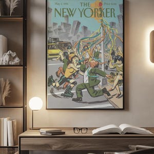 May include: A framed magazine cover print titled The New Yorker, dated May 2, 1994. The illustration depicts a city street scene with people dancing around a traffic light pole decorated with colorful streamers, set against a backdrop of buildings.
