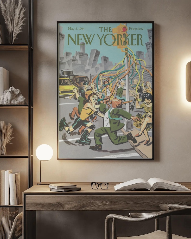 May include: A framed magazine cover print titled The New Yorker, dated May 2, 1994. The illustration depicts a city street scene with people dancing around a traffic light pole decorated with colorful streamers, set against a backdrop of buildings.