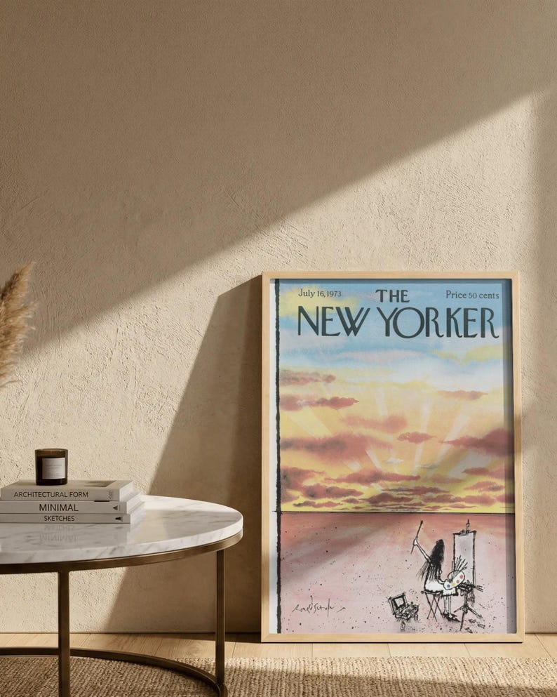 May include: A framed magazine cover of The New Yorker dated July 16, 1973, featuring a watercolor illustration of a sunset sky above a desert landscape with a figure painting at an easel. The text reads The New Yorker, July 16, 1973, Price 50 cents.