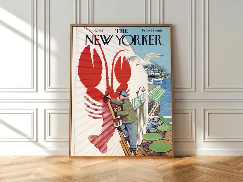 May include: A framed vintage New Yorker magazine cover from March 22, 1958, with a red lobster illustration. The cover art shows a man painting a building with a seagull flying above. The magazine title is in bold black letters.
