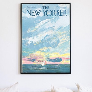 May include: Framed vintage New Yorker magazine cover from June 14, 1969, featuring a seascape with a sailboat under a colorful sky. The artwork is in shades of blue, pink, yellow, and white, with the magazine title at the top.