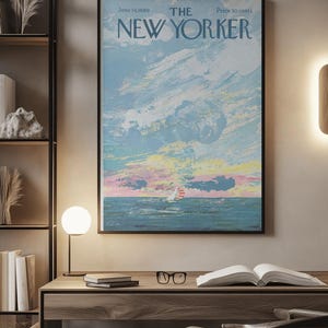 May include: A framed New Yorker magazine cover from June 14, 1969, featuring a seascape with a sailboat under a colorful sky. The artwork has a vintage aesthetic, with a black frame and the magazine's title at the top.