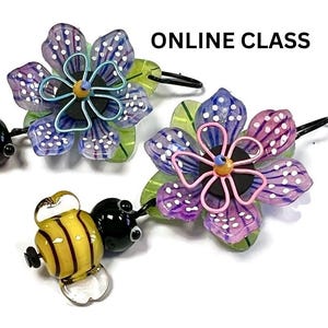 May include: Glass hair accessories featuring colorful flower and bee designs. The flowers are purple, blue, and pink with white polka dots. The bees are yellow with black stripes. The text "ONLINE CLASS" is visible.