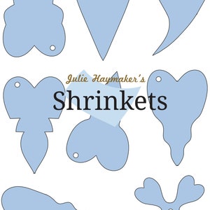 May include: Nine light blue shrink plastic templates for crafting. The templates are in the shapes of a heart, a flower, a cloud, and various other abstract shapes. Each template has a small hole punched in the top for hanging.