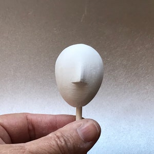 small oval plaster doll head ready to paint