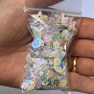 1 ounce - sequins mix white, ivory transparent and iridescent . round , horse eye ,flower