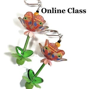 May include: A pair of floral earrings with a pink and orange flower design. The earrings are made with glass beads and have a silver hook.