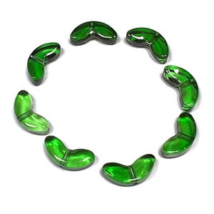 May include: Eight green glass beads in the shape of a crescent moon. The beads are arranged in a circle.