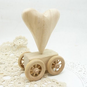 rolling  hand carved wooden heart on wheels ready to decorate.
