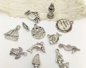 13 seaside theme charms most double sided in antique silver.
