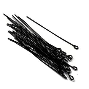 May include: A bundle of black head pins with a loop at the end. The pins are approximately 1 inch long.