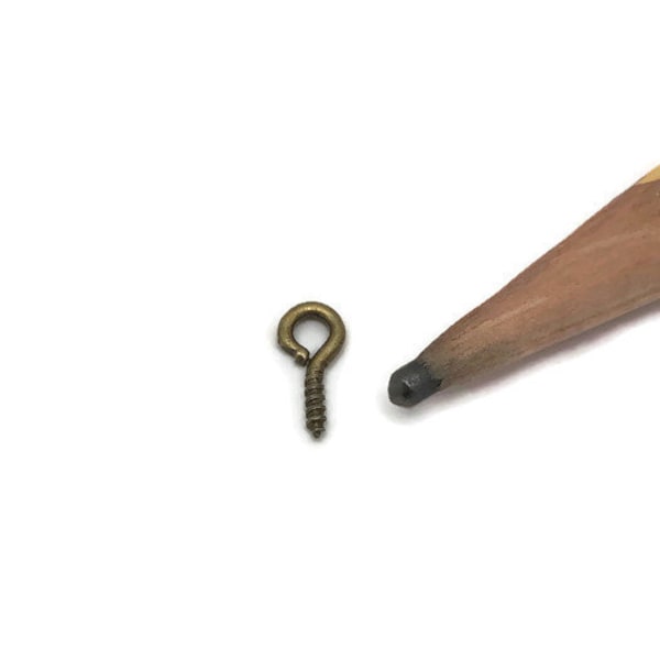 1/4 dry oz- tiny  eye hook screws in antique  bronze