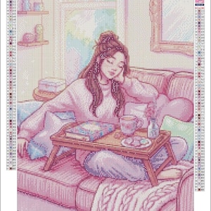 May include: A diamond painting kit titled Lost in the Moment featuring a person with brown hair sitting on a pink sofa with a wooden tray holding a book, a mug, and a small vase. The image includes a color legend, the text Eleven Lilacs, and 40x56.