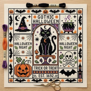 May include: A cross-stitch pattern on white fabric featuring a black cat, a cauldron, a skull, and pumpkins. The text reads GOTHIC HALLOWEEN, HALLOWEEN NIGHT, TRICK OR TREAT, and EST. 1692. Black and orange embroidery floss and gold scissors are included.