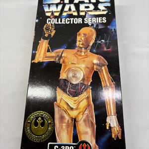 May include: A Star Wars Collector Series box featuring C-3PO. The box has a black background with the Star Wars logo and a gold-colored C-3PO figure. The box also includes the text "Collector Series", "C-3PO", and "Ages 5 & Up".