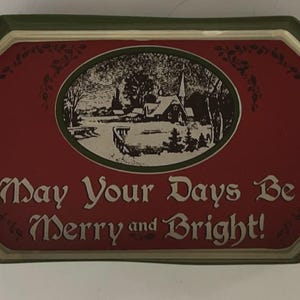 May include: A decorative serving tray with a red center featuring a winter scene and the text "May Your Days Be Merry and Bright!" The tray has a green border and black handles.