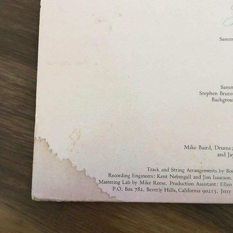 May include: A white record album cover with black text. The text reads "Track and String Arrangements by Boc Recording Engineers: Kent Nebergall and Jim Isaacson. Mastering Lab by Mike Reese. Production Assistant: Ellen P.O. Box 782, Beverly Hills, California 90213. Jerry"