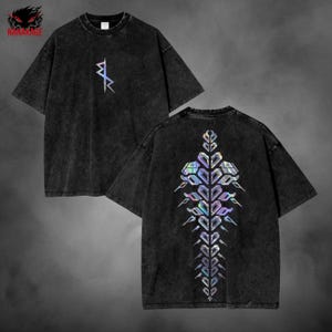 May include: Two black t-shirts with short sleeves. One shirt has a small, iridescent geometric design on the front. The other shirt has a large, iridescent geometric design on the back. The shirts have a washed, vintage look.