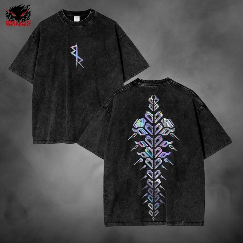 May include: Two black t-shirts with short sleeves. One shirt has a small, iridescent geometric design on the front. The other shirt has a large, iridescent geometric design on the back. The shirts have a washed, vintage look.