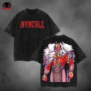 May include: Black t-shirts with a distressed look. One shirt has the word "INVINCIBLE" in red block letters. The other shirt features a graphic of a muscular character with a white fur collar and braids. The brand logo is in the upper left corner.