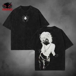 May include: Black t-shirt with a white spider graphic on the front and a white anime-style character on the back. The shirt has short sleeves and a relaxed fit. The brand logo "NANAKAGE" is in the top left corner.