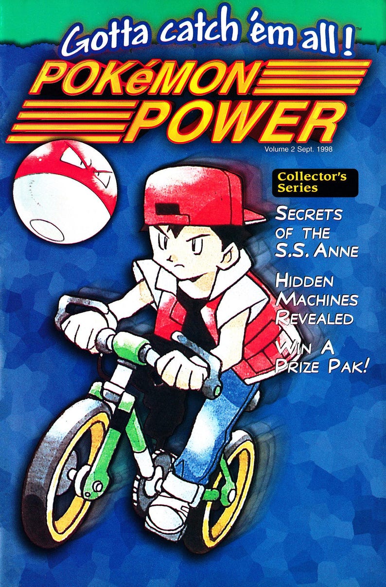 Pode incluir: Capa de banda desenhada Pok&eacute;mon Power, Volume 2, com uma personagem a andar de bicicleta verde e amarela. A capa inclui o texto "Gotta catch 'em all!" e "Collector's Series".