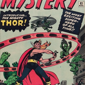 May include: Comic book cover for "Journey Into Mystery" featuring Thor. The cover has a red and white title, with Thor in a black and red costume, wielding a hammer. Green creatures and a flying saucer are also depicted.