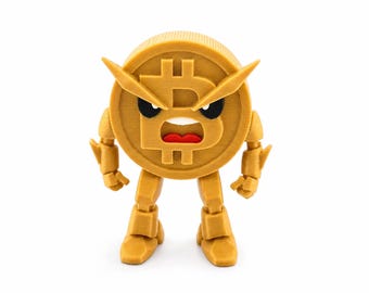 Puede incluir: Una figura impresa en 3D de color dorado con forma de moneda Bitcoin circular con un símbolo B central. El personaje presenta una expresión facial de enfado con ojos negros, cejas afiladas y una boca roja, junto con brazos y piernas articulados.