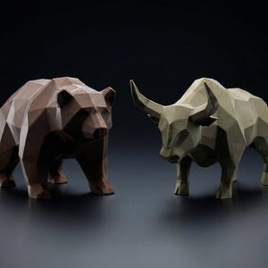 May include: A brown bear and a light green bull, both with geometric, faceted designs, stand side-by-side against a dark background. The bear is on the left, and the bull is on the right. The sculptures are likely decorative items or symbols of market trends.