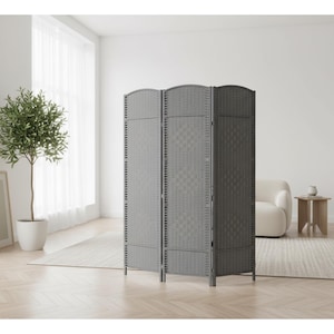May include: A gray, three-panel room divider with a woven texture. The screen has a curved top and is freestanding. The room divider is in a bright, modern room with a tree in a white pot and a framed picture.