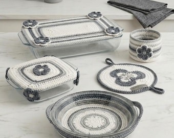 May include: Crochet HearthStitch Tableware Pattern Instant PDF Download. A collection of white and gray crocheted covers for glass baking dishes, a small round basket, and a circular hot pad, all featuring floral accents and striped patterns.